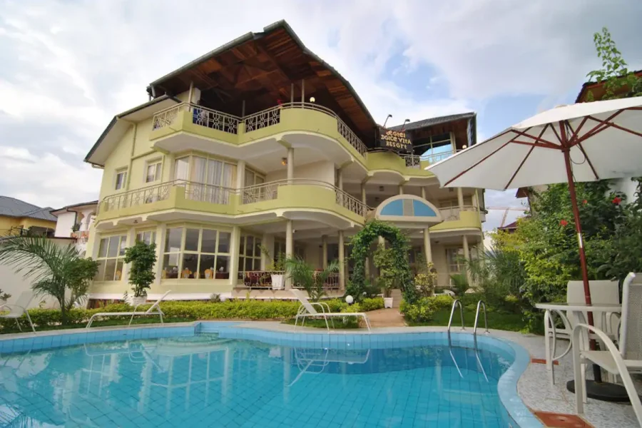 a pool and umbrellas at Dolce vita hotel in Bujumbura, Burundi