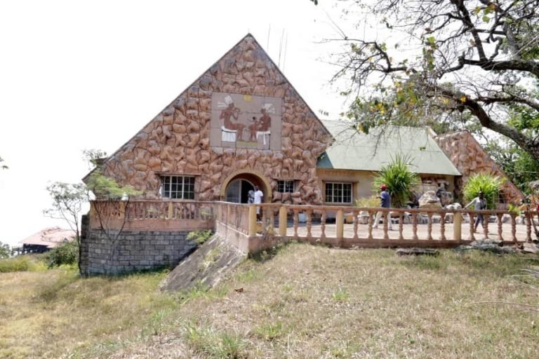 a stone house with a stone wall in Rumonge