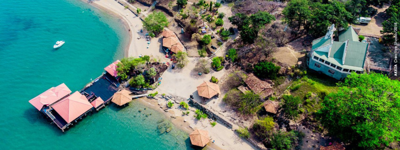 a aerial view of a beach in Burundi with houses and trees