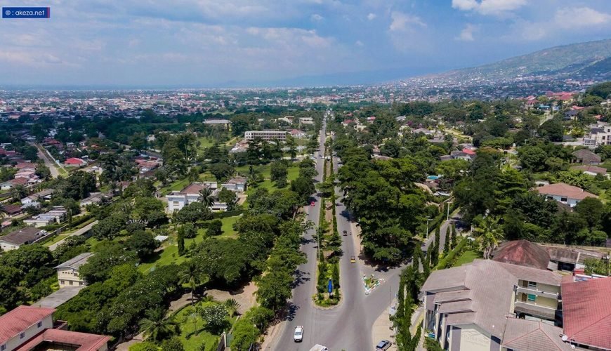 a road with trees and buildings in Bujumbura