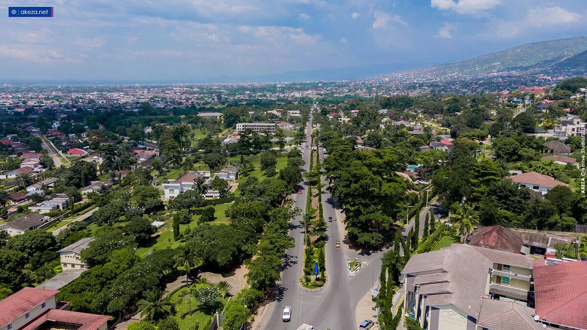 a road with trees and buildings in Bujumbura