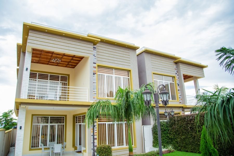 an apartment with palm trees in the garden